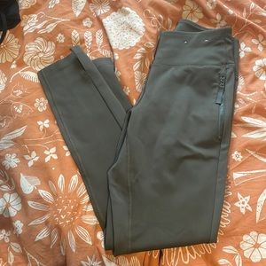 Hunter green leggings with zipper pockets and ankle split
